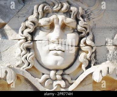 Closeup of a face carved on marble in classical style by ancient Greeks at the Temple of Apollo in Didyma. An impressive ruined sanctuary or statue in Hellenic city of Miletus, in southwest Turkey Stock Photo