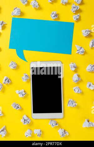 Paper Wraps Placed Around Tablet And Speech Bubble With Important Informations. Wrinkled Notes Arranged All Over Dialogue Balloon And Phone Screen With Crutial Announcements. Stock Photo