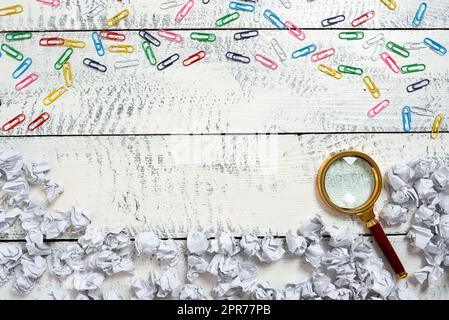 Paper Wraps And Paperclips Around Magnifier And Important Informations. Crumpled Notes And Colorful Clips All Over Magnifying Glass And Crutial Announcement. Stock Photo