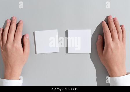 Businesswoman Presenting Different Crutial Messages On Two Notes. Woman Showing Important Informations On Memos. Executive Displaying Recent Updates. Stock Photo