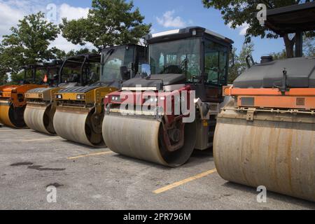 several steamrollers on road construction site heavy equipment asphalt paving roller compactor Stock Photo