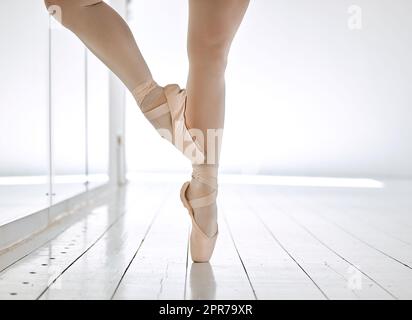 In ballet, technique is everything. an unrecognizable female ballet student rehearsing in her dance studio. Stock Photo