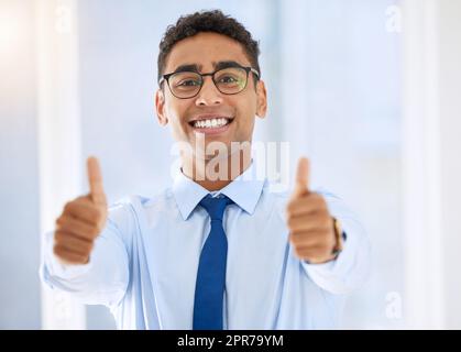 Giving it my best. a young businessman giving the thumbs up. Stock Photo