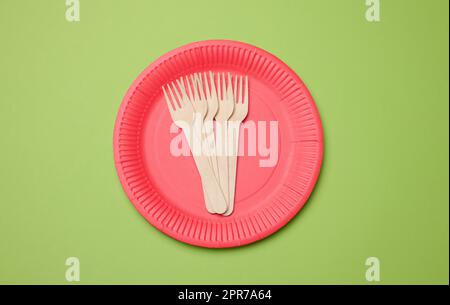 Wooden fork and empty round red disposable plate Stock Photo