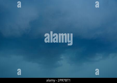 dark storm clouds before rain storm in blue tones Stock Photo