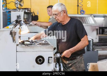 Bila Tserkva, July, 2020: locksmith working on a lathe in a factory Stock Photo