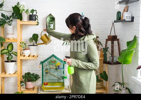 A woman waters home plants from her collection of rare species from a ...