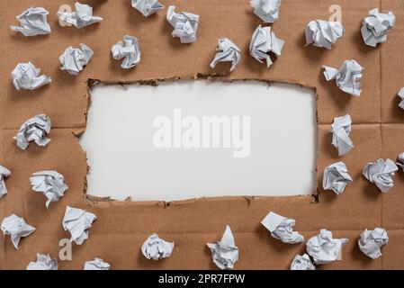 Important Informations Written Under Ripped Cardboard With Paper Wraps Around. Crutial Announcements Underneath Torn Paperboard With Crumpled Notes All Over. Stock Photo