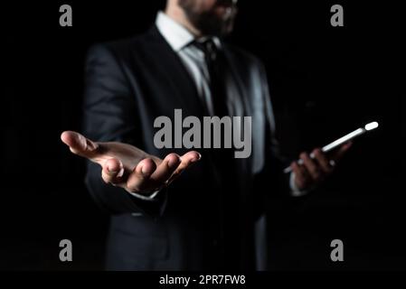 Businessman Holding Phone In One Hand In Other Important Message. Executive In Suit Having Cellphone In One Palm And Crutial Announcement In Another. Stock Photo