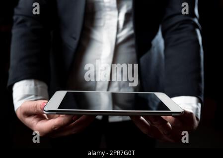 Businesswoman Holding Tablet And Presenting Important Informations. Woman Showing Recent Updates On Screen. Executive Displaying Late Achievements On Cellphone. Stock Photo