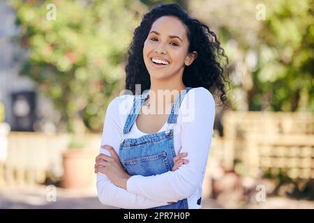 There is beauty in nature. a beautiful young woman with folded arms standing outdoors. Stock Photo