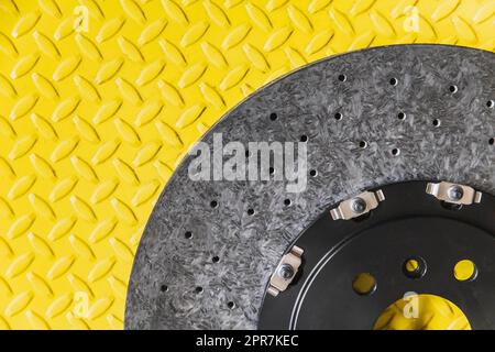 new carbon brake disc on yellow background Stock Photo