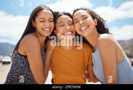 A sweet friendship refreshes the soul. Portrait of a group of young women hanging out together outdoors. Stock Photo