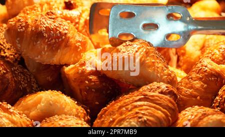 French pastries croissant at a hotel on the breakfast. Fresh croissant  in luxury hotel breakfast buffet, restaurant interior. Stock Photo