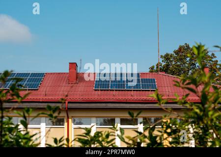 Photovoltaic or solar panels on a red roof Stock Photo