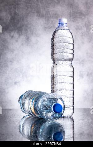 Two plastic cold bottles of water with water drops. Stock Photo