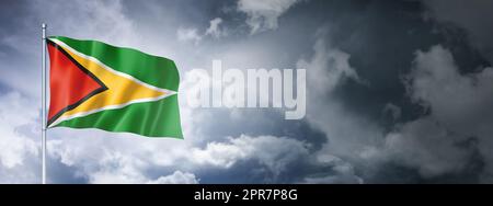 Guyanese flag on a cloudy sky Stock Photo