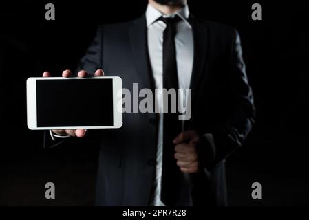 Businessman Presenting Important Informations On Phone Screen. Man In Suit Showing Crutial News On Cellphone. Executive Displaying Recent Updates On Tablet. Stock Photo
