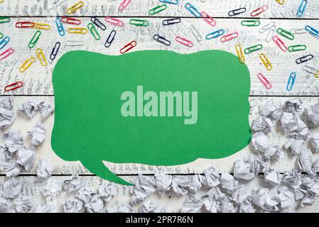 Speech Bubble With Important Ideas Divided On Half With Paper Wraps Underneath And Paperclips Above. Dialogue Balloon With Crutial News Inside With Crumpled Notes And Clips. Stock Photo