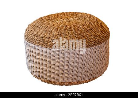 Wicker furniture. Close-up of a wickerwork stool in round shape as seating in hotels and by the pool isolated on a white background. Pool accessories. Stock Photo