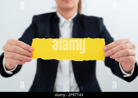 Businesswoman Holding Note With Important Message With Both Hands. Woman Presenting Crutial Information On Piece Of Paper. Executive Showing Critical Announcement. Stock Photo
