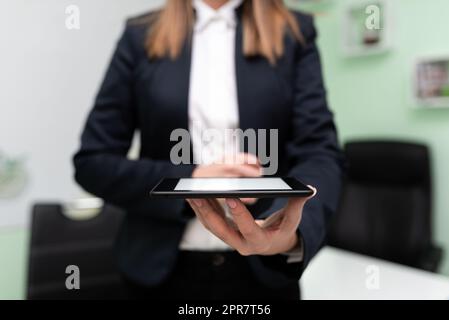 Businesswoman Holding Tablet And Presenting Important Message. Woman Having Phone In Hands And Showing Crutial Information. Executive Displaying Recent Updates. Stock Photo
