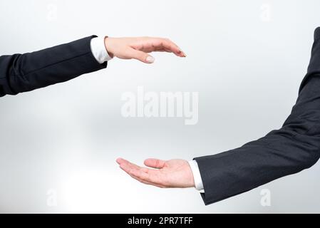 Important Message Presented Between Business Team Hands. Crutial Information Displayed Among Two Palms. Critical Announcements Shown From Man And Woman. Stock Photo