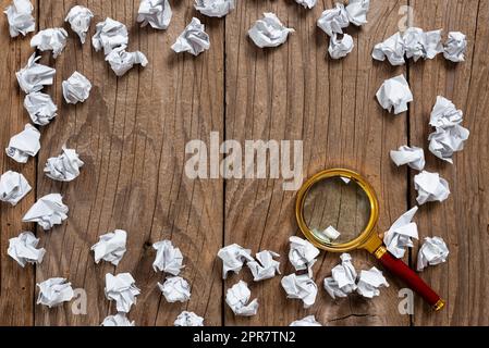 Paper Wraps And Magnifier Placed Around Important Information. Wrinkled Notes Arranged In Circle With Crutial Announcement Inside. Crumpled Memos With Critical Data In. Stock Photo