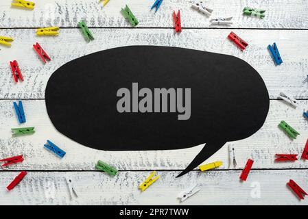 Colorful Pegs Placed Around Speech Bubble With Important Information. Wooden Clips Arranged All Over Dialogue Ballon With Crutial Idea. Pins With Critical Data Inside. Stock Photo