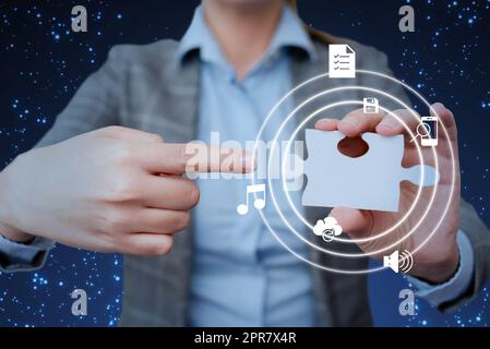 Lady in suit pointing puzzle piece representing innovative thinking symbolizing futuristic technology. Woman carrying jigsaw displays successful creative thinking. Stock Photo