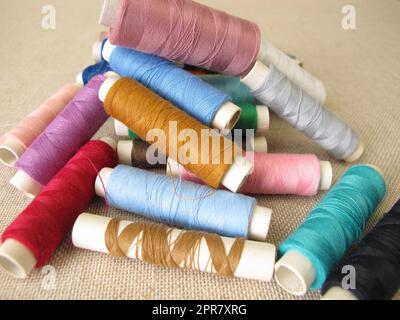 Sewing thread in different colors on farbric Stock Photo