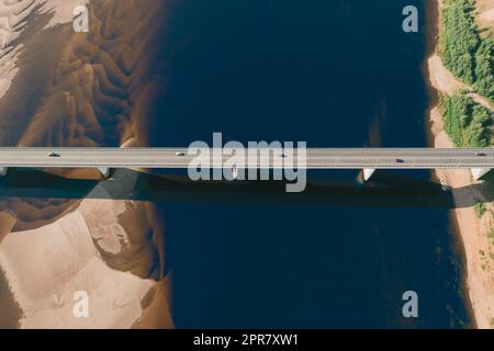 aerial car bridge over river with sandy dunes coast Stock Photo