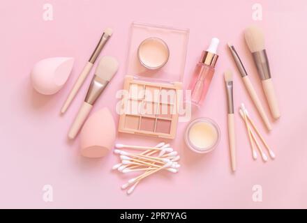 Natural beige eye shadow and decorative cosmetics on light pink, top view Stock Photo