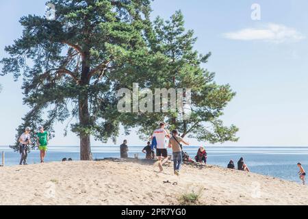 People rest on the banks of the river in Ukraine Stock Photo