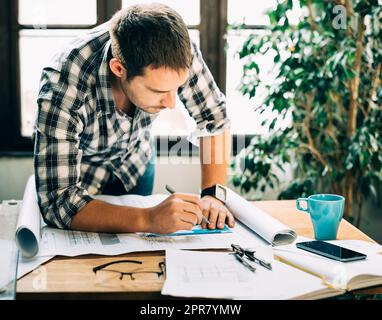 Man working on architectural project Stock Photo