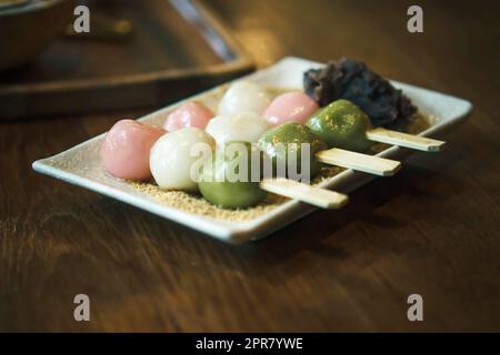 Three Color Japanese  Hanami Dango Dumpling sweet dessert on white ceramic plate. Stock Photo