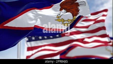 The American Samoa flags waving along with the national flag of the USA Stock Photo