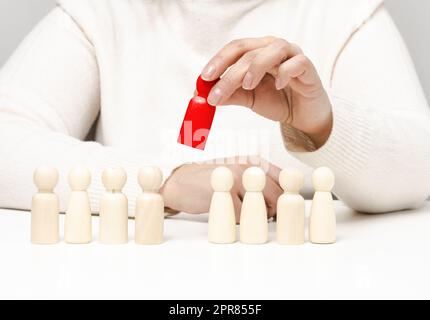 Figurines of men on a white table. concept of searching for employees in the company Stock Photo