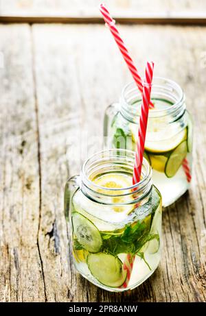 Lemon and cucumber drink in retro jars Stock Photo