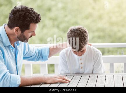 You can talk to me about anything. Shot of a father consoling his son at home. Stock Photo