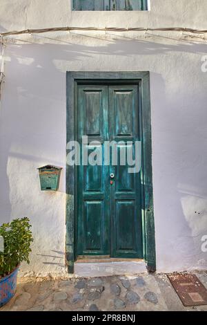 Vintage of wooden door on historical street in tropical village or