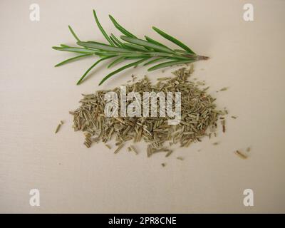 Dried and chopped rosemary on a wooden board Stock Photo