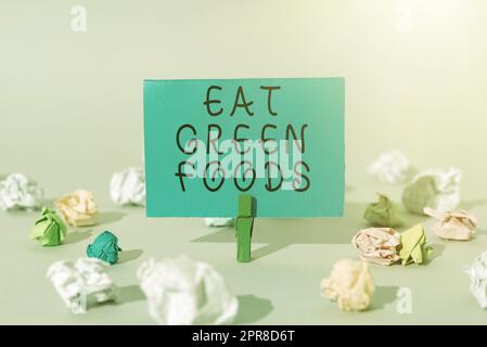Handwriting text Eat Green Foods. Conceptual photo Eating more vegetables healthy diet vegetarian veggie person Important Message Presented On Piece Of Paper Clipped With Clip. Stock Photo