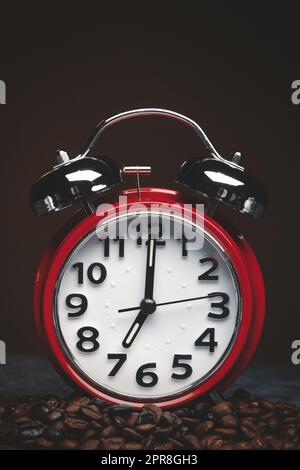 front view of brown coffee seeds with clocks on dark background textured grain group Stock Photo