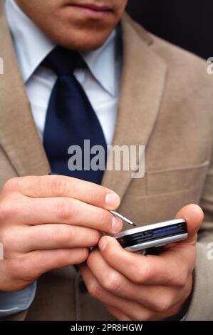 Checking my calender. Closeup shot of a businessman checking his mobile calender. Stock Photo