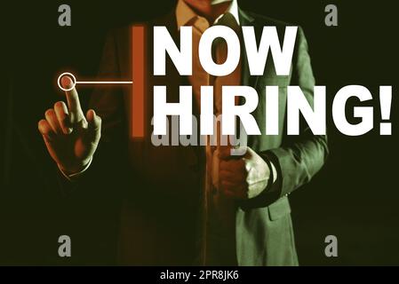 Text caption presenting Now Hiring. Conceptual photo announcing that certain company seeking for new talents Businessman In Suit Pointing With One Finger On Important Message. Stock Photo