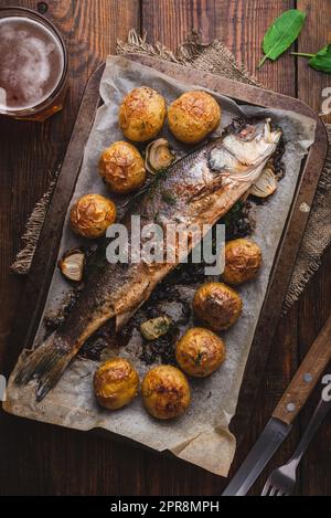 Sea Bass Stuffed with Sorrel and Baked with Potatoes Stock Photo