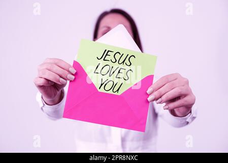 Text sign showing Jesus Loves You. Business overview Believe in the Lord To have faith religious person Woman Holding Letter And Envelope Sending Important Information. Stock Photo