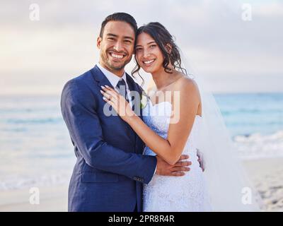 Its our big day today. a young couple on the beach on their wedding day. Stock Photo