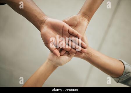 Each of the four hands is clasped around the friends wrist. One hand grips  the other, and so on. Young girls hands. Stock Photo by ©info.fotodrobik.pl  424891214